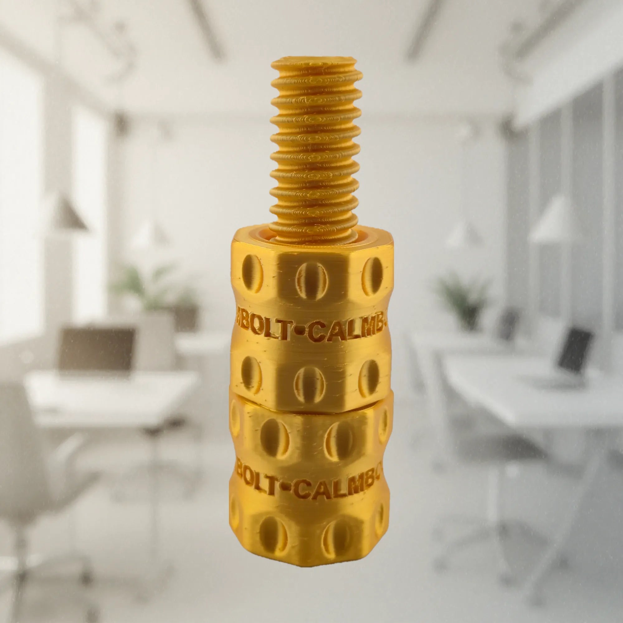 CalmBolt Aurum tactile fidget with reflective gold finish and refined rotating structure