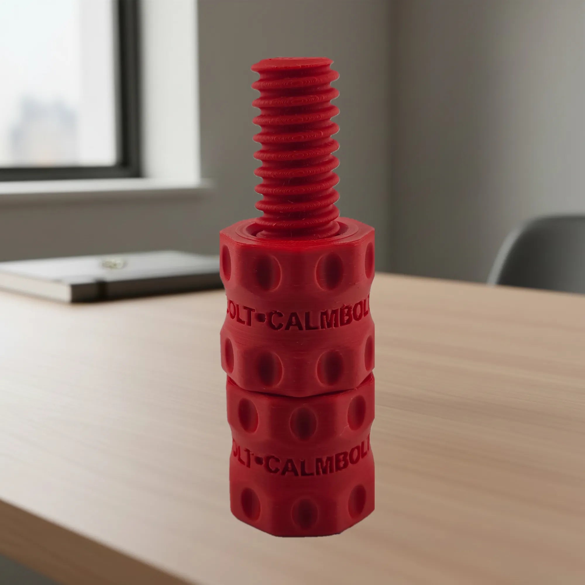 CalmBolt Cherry tactile fidget with bold red finish and threaded multi-part design